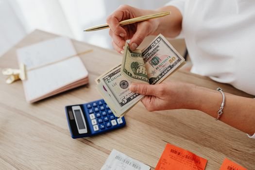 Seorang pemilik usaha kecil sedang serius menghitung laporan keuangan, menunjukkan pentingnya pencatatan detail untuk memahami kondisi finansial bisnis. Pengelolaan keuangan yang cermat adalah kunci keberlanjutan setiap UMKM.